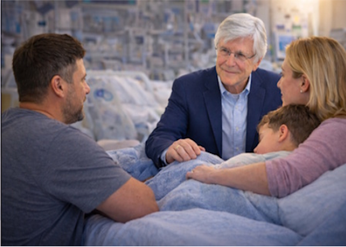 Chaplain Steven St John speaking with a family in a hospital setting